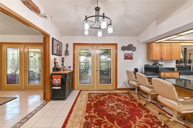 office featuring a chandelier, french doors, light tile patterned floors, and lofted ceiling