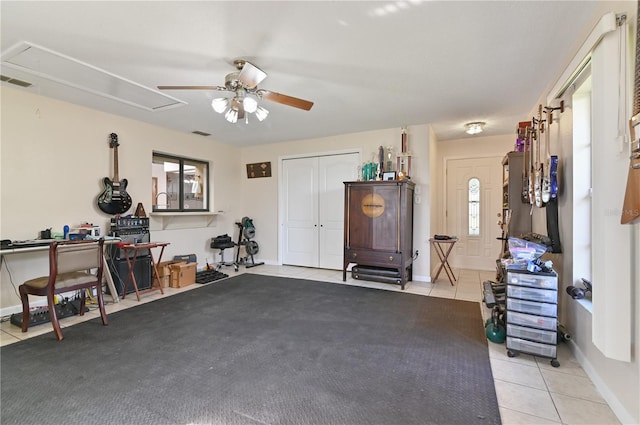 misc room featuring plenty of natural light, light tile patterned flooring, and ceiling fan