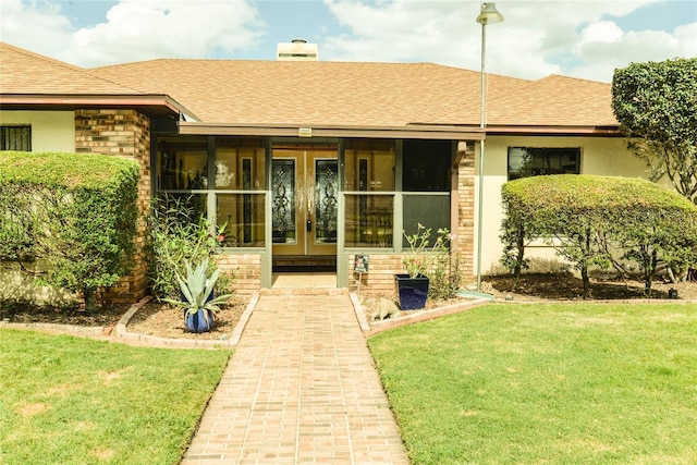 entrance to property with a yard