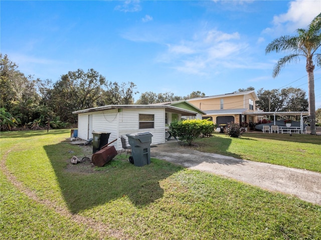 exterior space featuring a yard and a carport