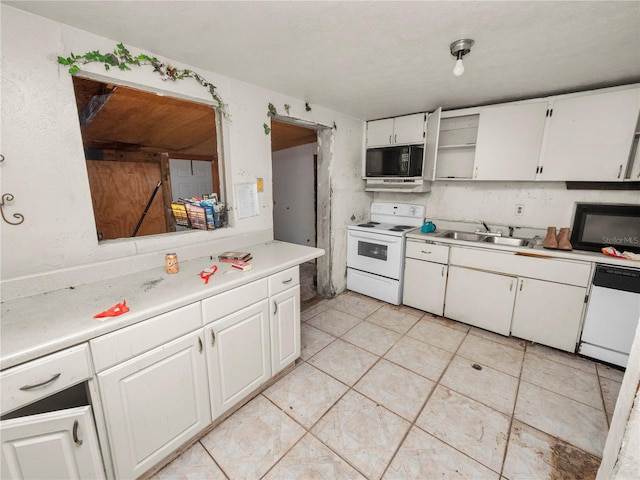 kitchen featuring white cabinets, white appliances, light tile patterned floors, and sink