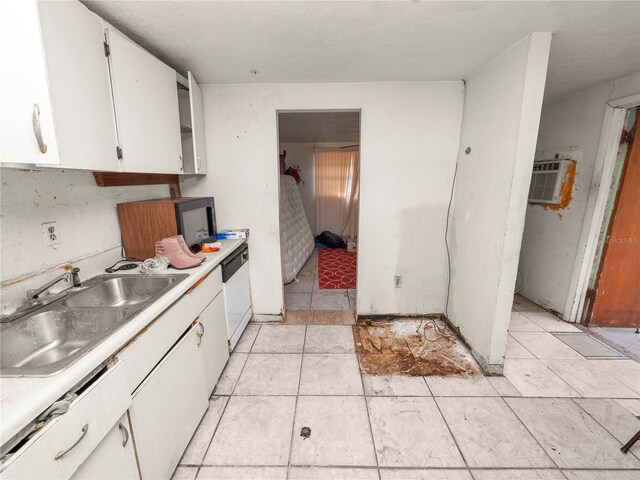 kitchen with dishwasher, sink, white cabinets, and a wall mounted air conditioner