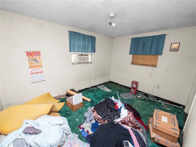 bedroom featuring a textured ceiling, dark colored carpet, and cooling unit