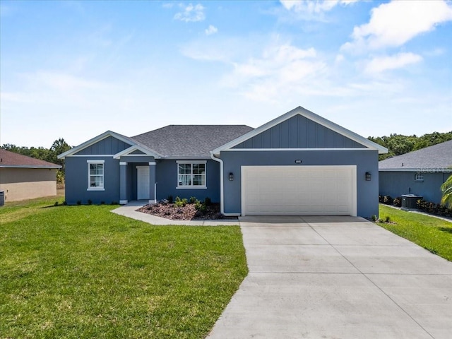 ranch-style home with cooling unit, a front lawn, driveway, and an attached garage