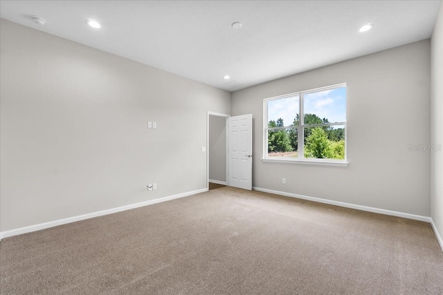 unfurnished room with baseboards, recessed lighting, and carpet floors