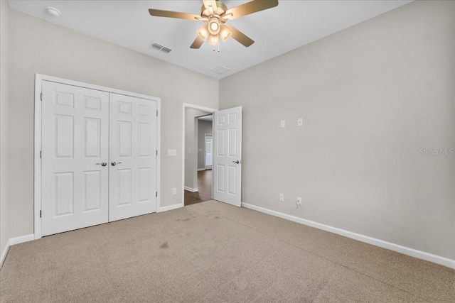 unfurnished bedroom with carpet flooring, a closet, a ceiling fan, visible vents, and baseboards