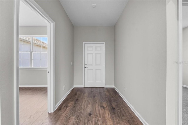 doorway to outside featuring dark wood finished floors and baseboards