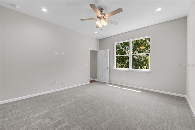 empty room with recessed lighting, a ceiling fan, carpet flooring, and baseboards