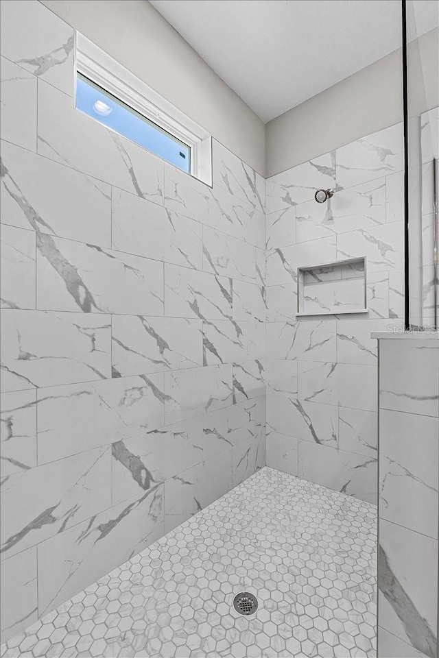 full bath featuring a tile shower