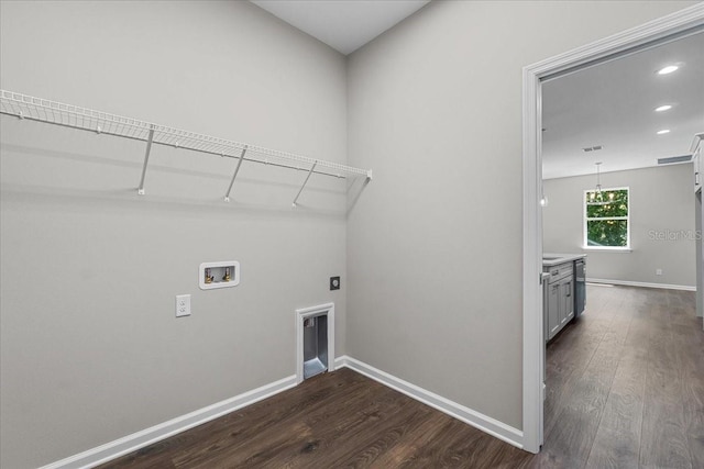 washroom with dark wood finished floors, washer hookup, laundry area, and hookup for an electric dryer