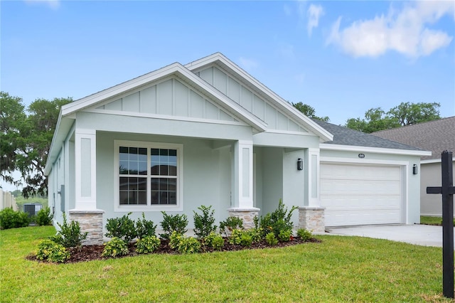 view of front of home with a garage, stucco siding, a front yard, board and batten siding, and driveway