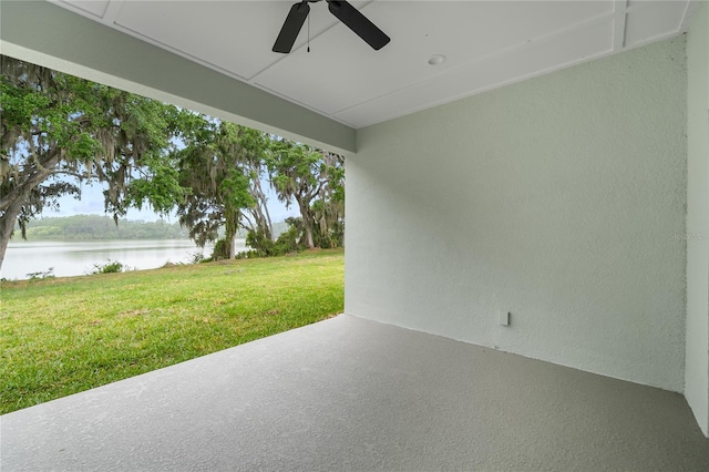 view of patio / terrace featuring a ceiling fan and a water view
