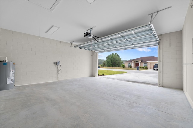 garage featuring a garage door opener and electric water heater