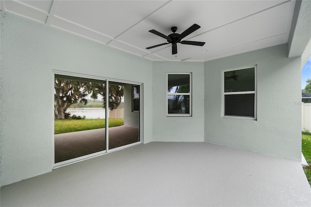 view of patio / terrace featuring a ceiling fan and a water view