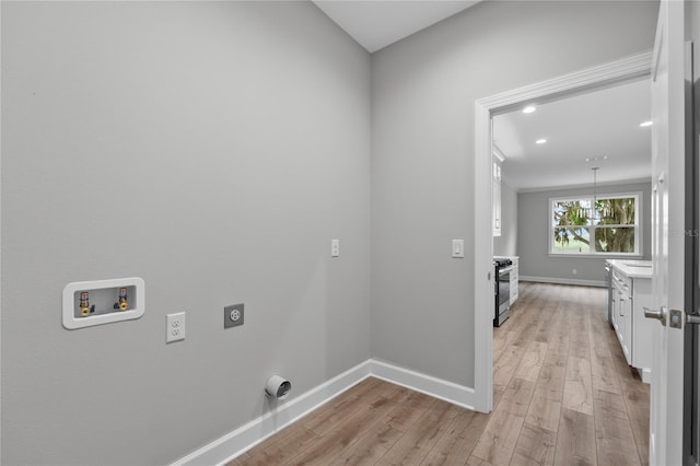 washroom featuring hookup for a washing machine, baseboards, laundry area, light wood-style floors, and electric dryer hookup