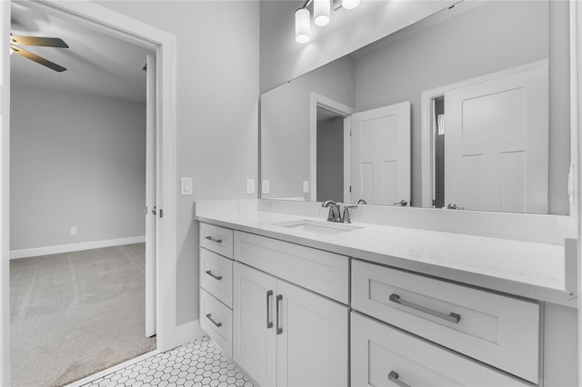 bathroom with baseboards, ceiling fan, and vanity