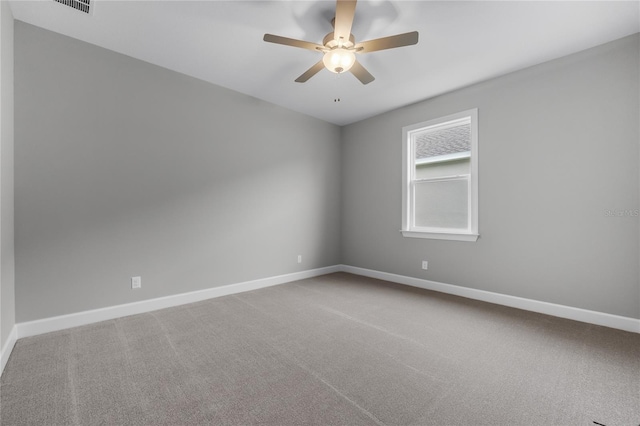 unfurnished room with baseboards, carpet floors, and a ceiling fan