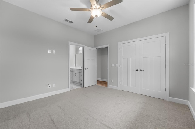 unfurnished bedroom with carpet floors, baseboards, and visible vents