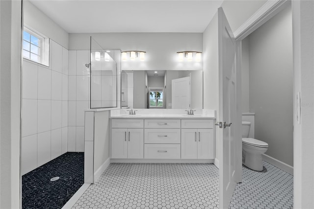 bathroom with toilet, a sink, double vanity, and a walk in shower
