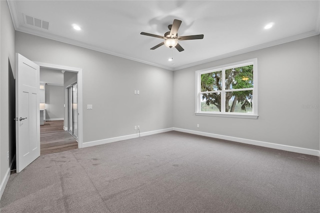 empty room with a ceiling fan, crown molding, baseboards, and visible vents