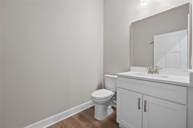 4537 Fairway Oaks Dr, Mulberry, FL 33860 - bathroom with toilet, wood finished floors, vanity, and baseboards