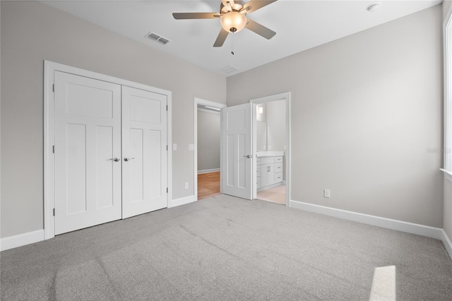 4537 Fairway Oaks Dr, Mulberry, FL 33860 - unfurnished bedroom with connected bathroom, a closet, visible vents, carpet flooring, and baseboards