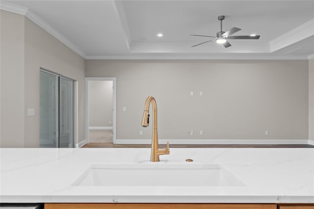 4537 Fairway Oaks Dr, Mulberry, FL 33860 - kitchen with a sink, a tray ceiling, crown molding, and ceiling fan