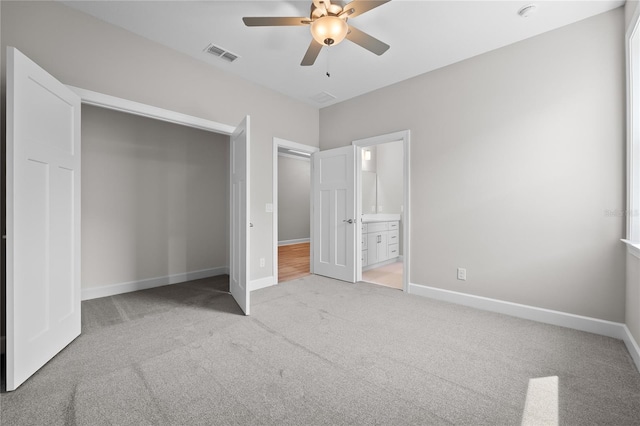 4537 Fairway Oaks Dr, Mulberry, FL 33860 - unfurnished bedroom featuring baseboards, carpet flooring, connected bathroom, visible vents, and ceiling fan