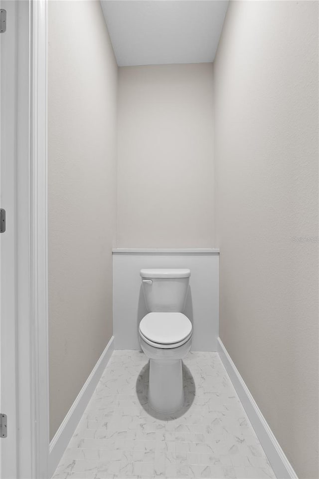 4537 Fairway Oaks Dr, Mulberry, FL 33860 - bathroom with toilet, marble finish floor, and baseboards