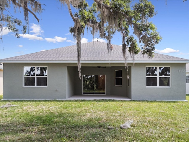 4537 Fairway Oaks Dr, Mulberry, FL 33860 - back of property featuring a yard, stucco siding, a shingled roof, and a patio area