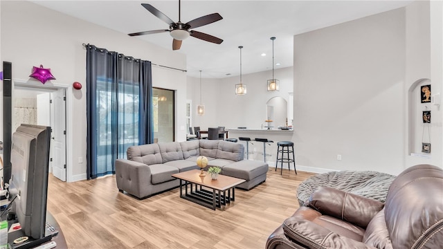 living room featuring ceiling fan and light wood-type flooring