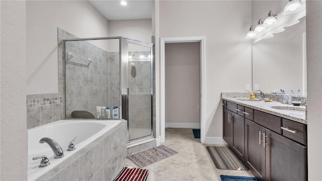 bathroom with dual vanity, plus walk in shower, and tile patterned floors