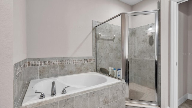 bathroom with separate shower and tub