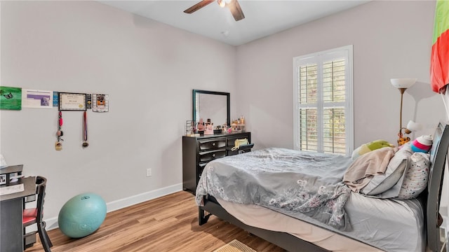 bedroom with ceiling fan and light hardwood / wood-style flooring