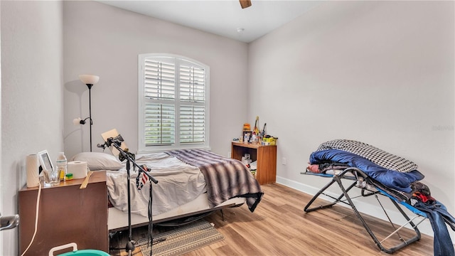 bedroom featuring ceiling fan and light hardwood / wood-style flooring