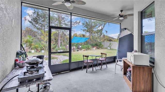 sunroom / solarium featuring ceiling fan