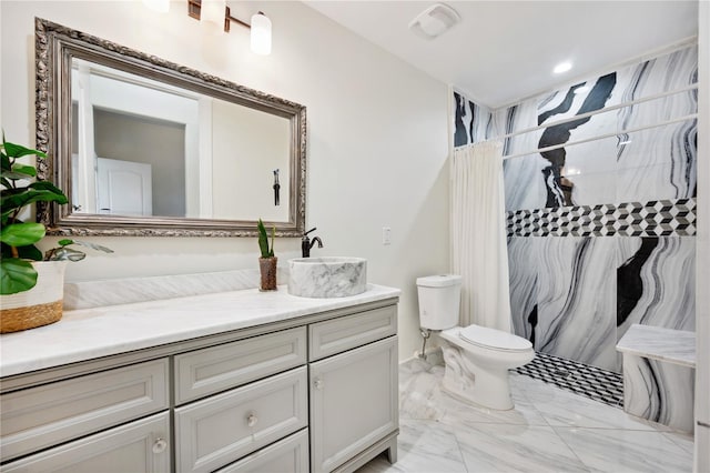 bathroom featuring toilet, marble finish floor, curtained shower, and vanity