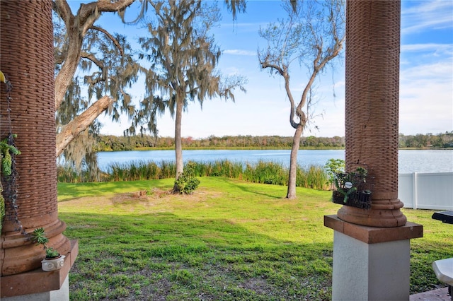 view of yard with a water view and fence