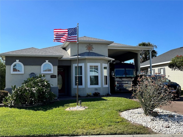 view of front of property with a front yard and a carport