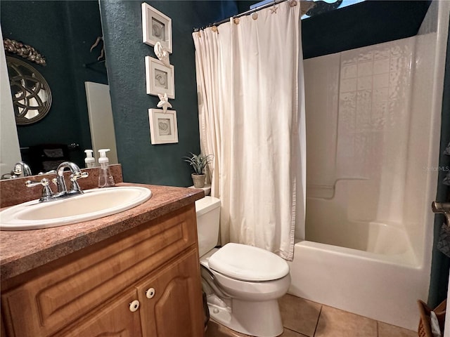 full bathroom with shower / tub combo, tile floors, vanity with extensive cabinet space, and toilet