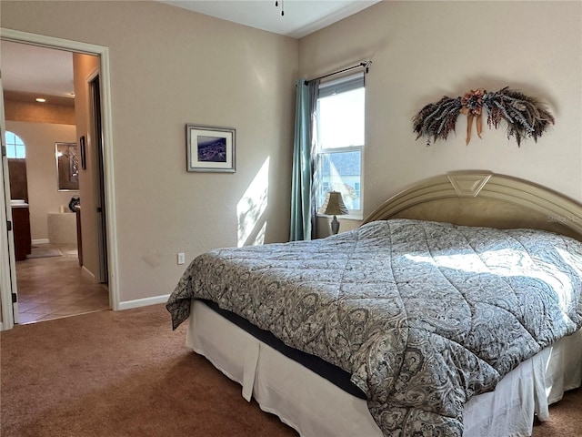 carpeted bedroom with ensuite bathroom