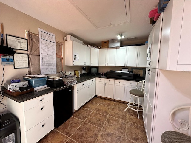 kitchen with dark tile floors and white cabinetry