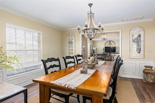 dining room with a chandelier, crown molding, and dark hardwood / wood-style flooring