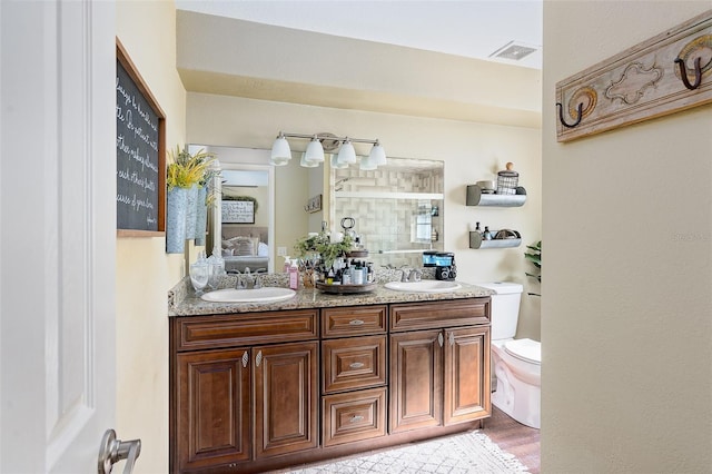 bathroom with hardwood / wood-style floors, vanity, and toilet