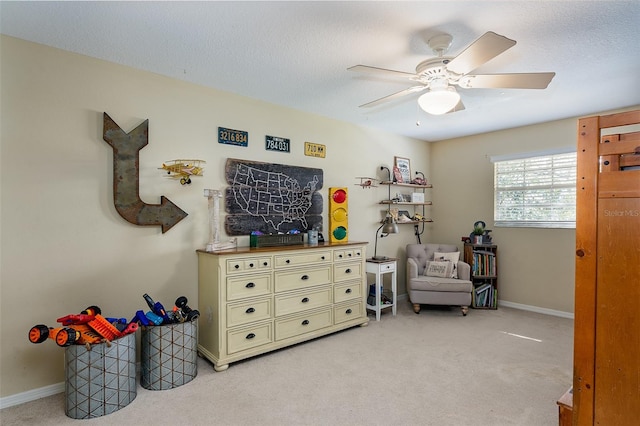 interior space featuring a textured ceiling, light colored carpet, and ceiling fan