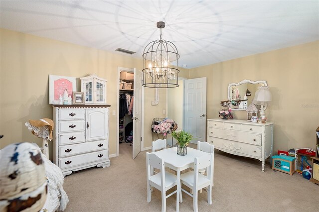 recreation room featuring light colored carpet and a notable chandelier