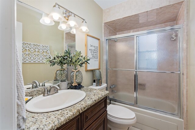 full bathroom with shower / bath combination with glass door, a chandelier, vanity, and toilet