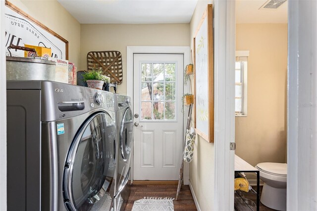 laundry area with separate washer and dryer and dark hardwood / wood-style floors