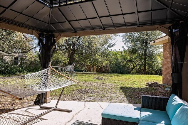 view of yard featuring outdoor lounge area, a patio, and a gazebo