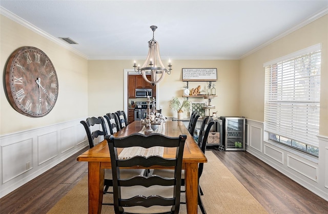 dining space featuring ornamental molding, dark hardwood / wood-style flooring, a notable chandelier, and wine cooler